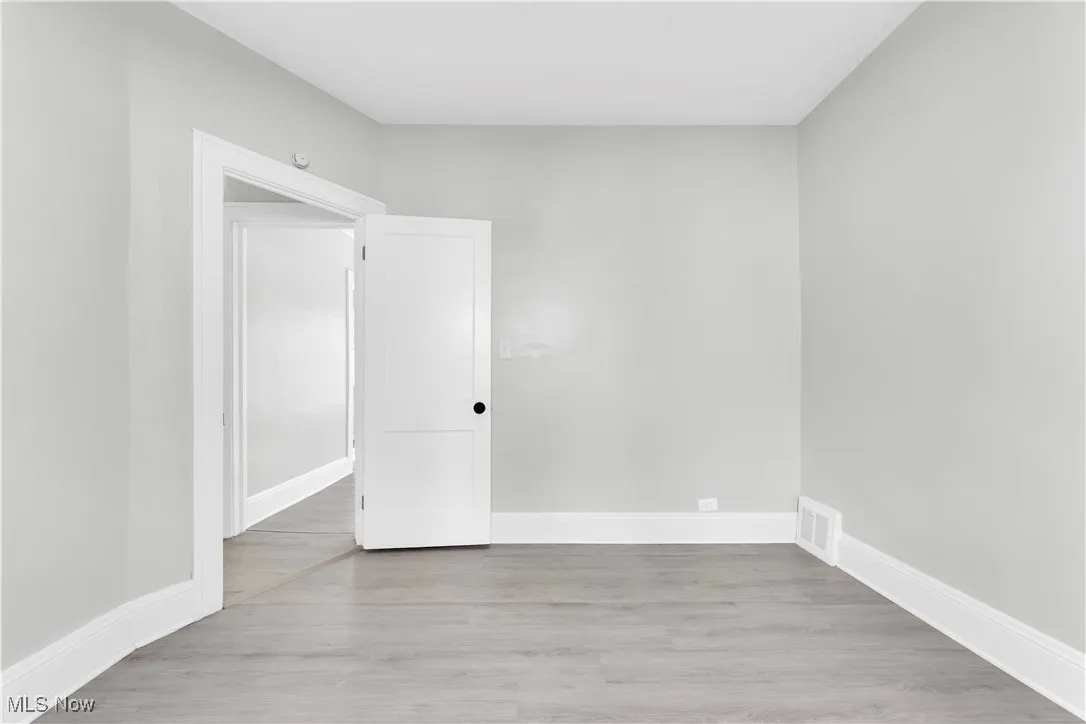 Empty room with wood finished floors and baseboards