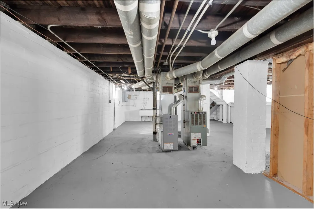 Unfinished basement featuring heating unit