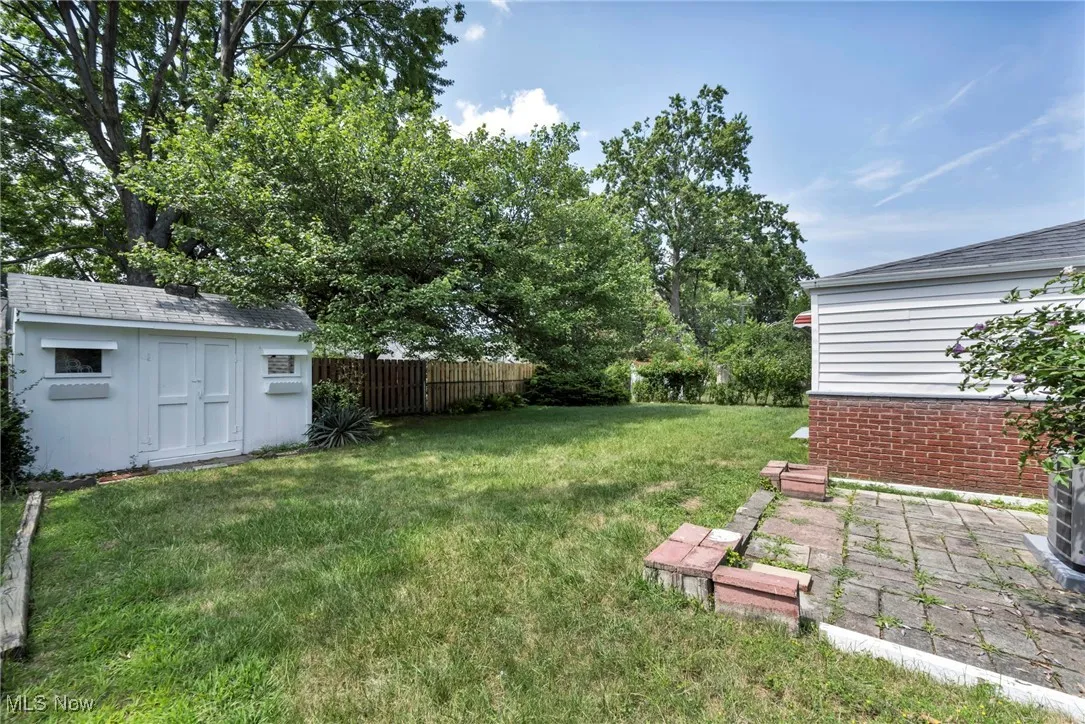 View of yard with a storage unit