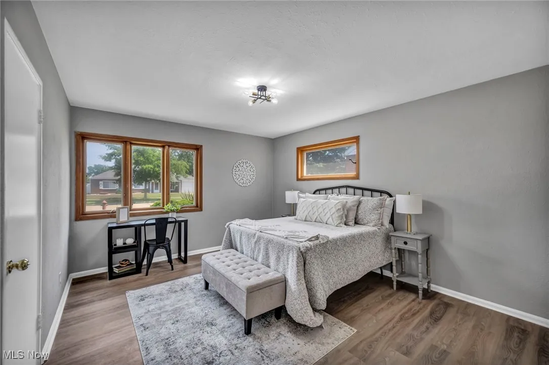 Bedroom featuring wood finished floors and baseboards