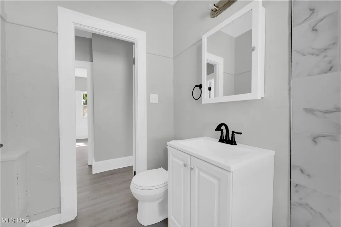 Bathroom featuring vanity and wood finished floors