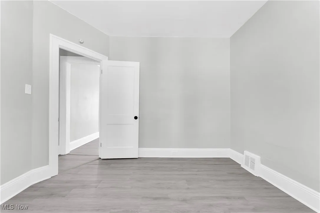 Empty room with wood finished floors and baseboards