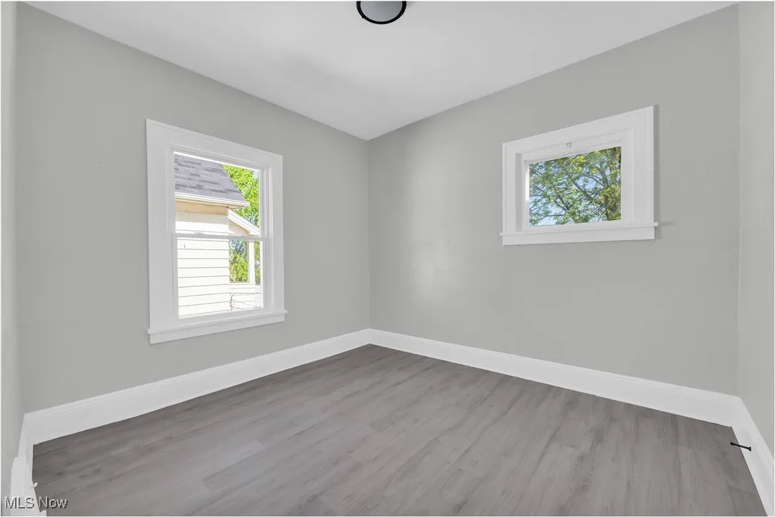 Spare room featuring wood finished floors
