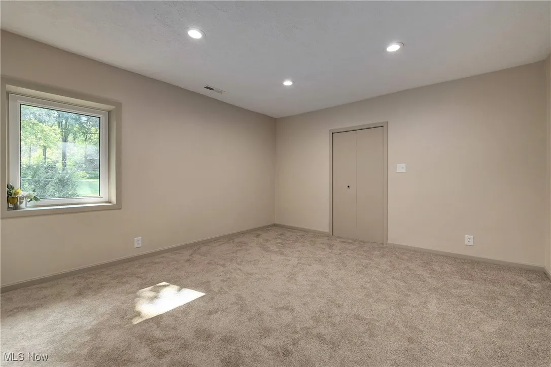 Spare room featuring carpet floors and recessed lighting