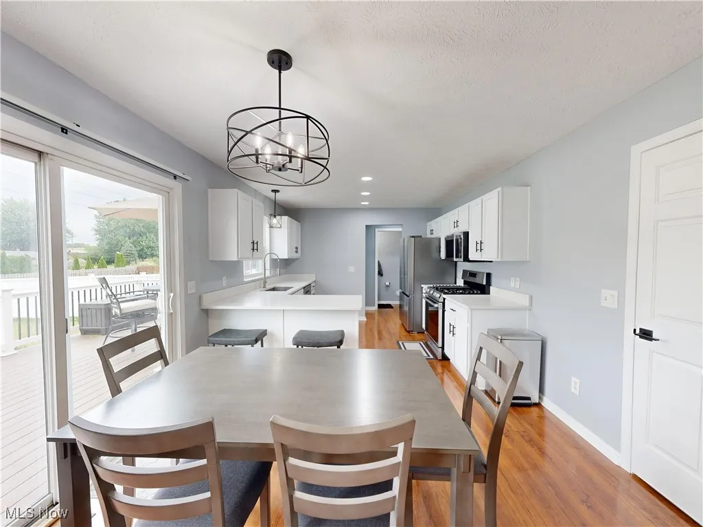 Dining area with light wood finished floors, a chandelier, and recessed​​‌​​​​‌​​‌‌​‌‌​​​‌‌​‌​‌​‌​​​‌​​ lighting