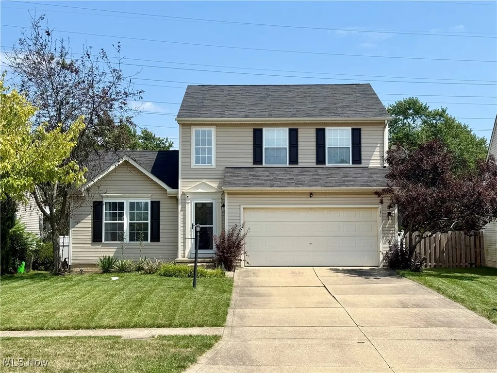 Traditional home with a garage and concrete driveway