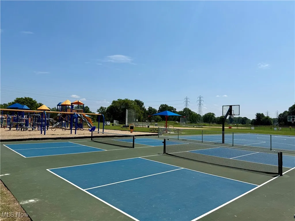 View of tennis court with community basketball court