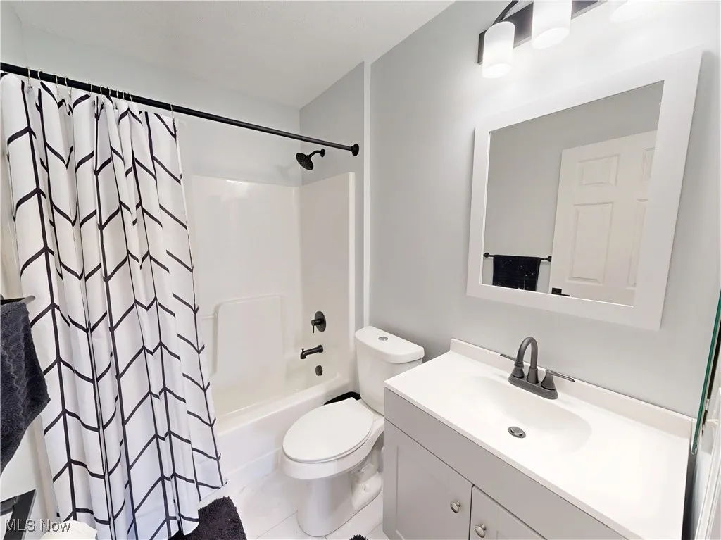 Bathroom with vanity and shower / bath combo