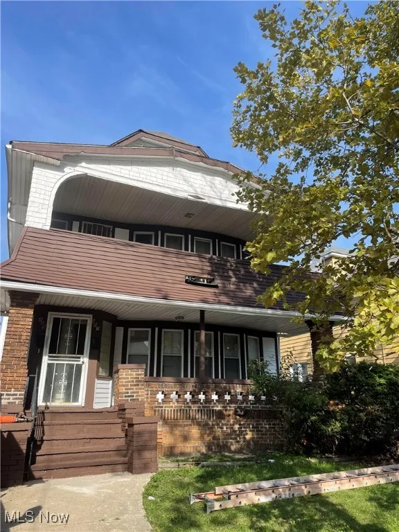 View of front of house featuring a balcony and a porch