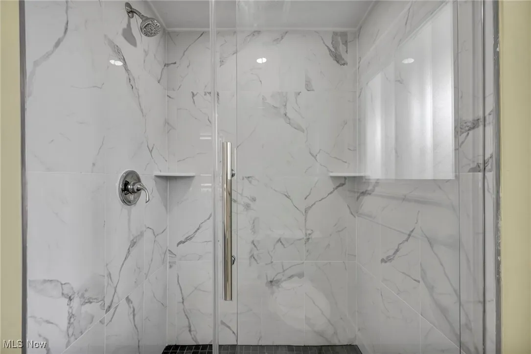 Bathroom with a marble finish shower