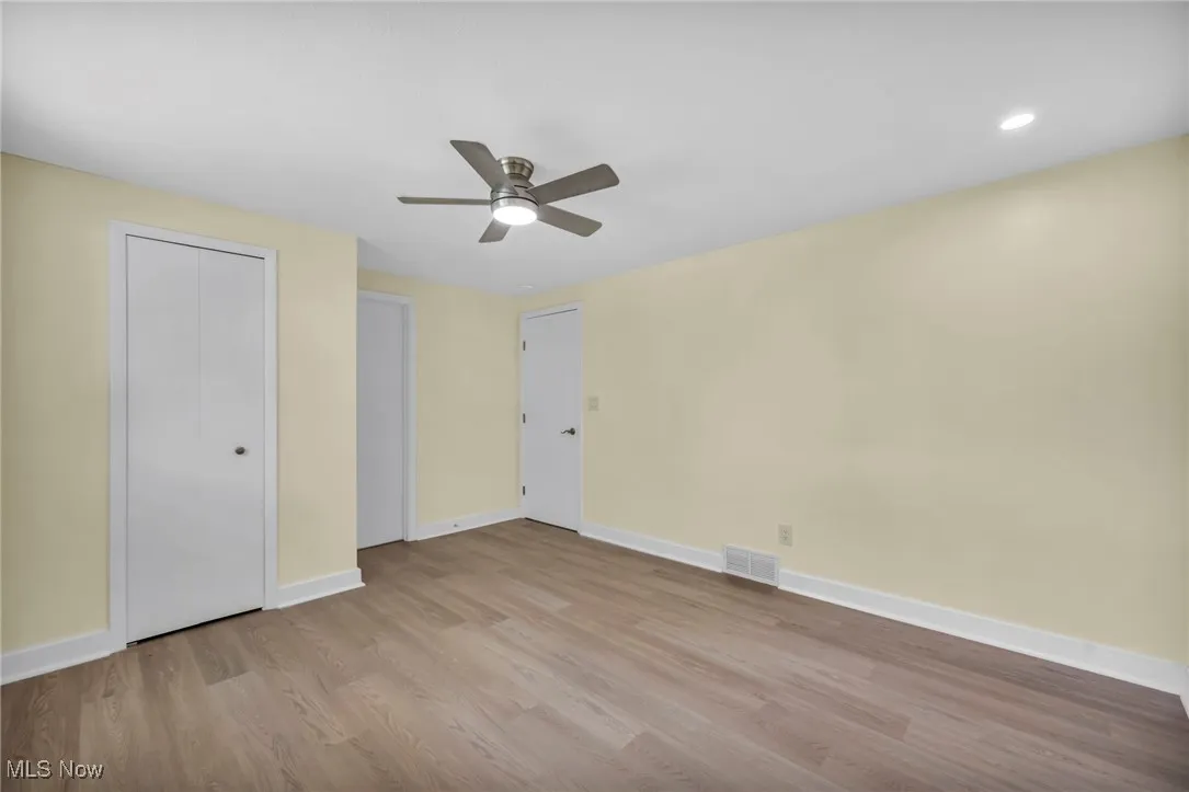Unfurnished bedroom with wood finished floors and ceiling fan