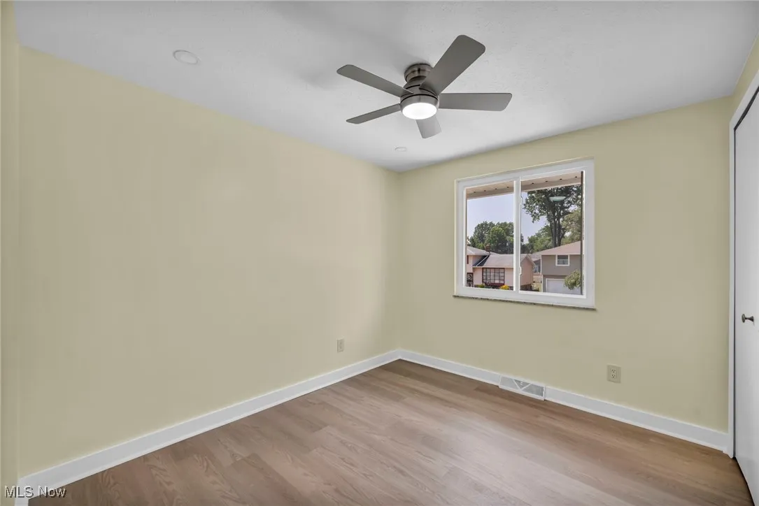 Spare room featuring wood finished floors and ceiling fan