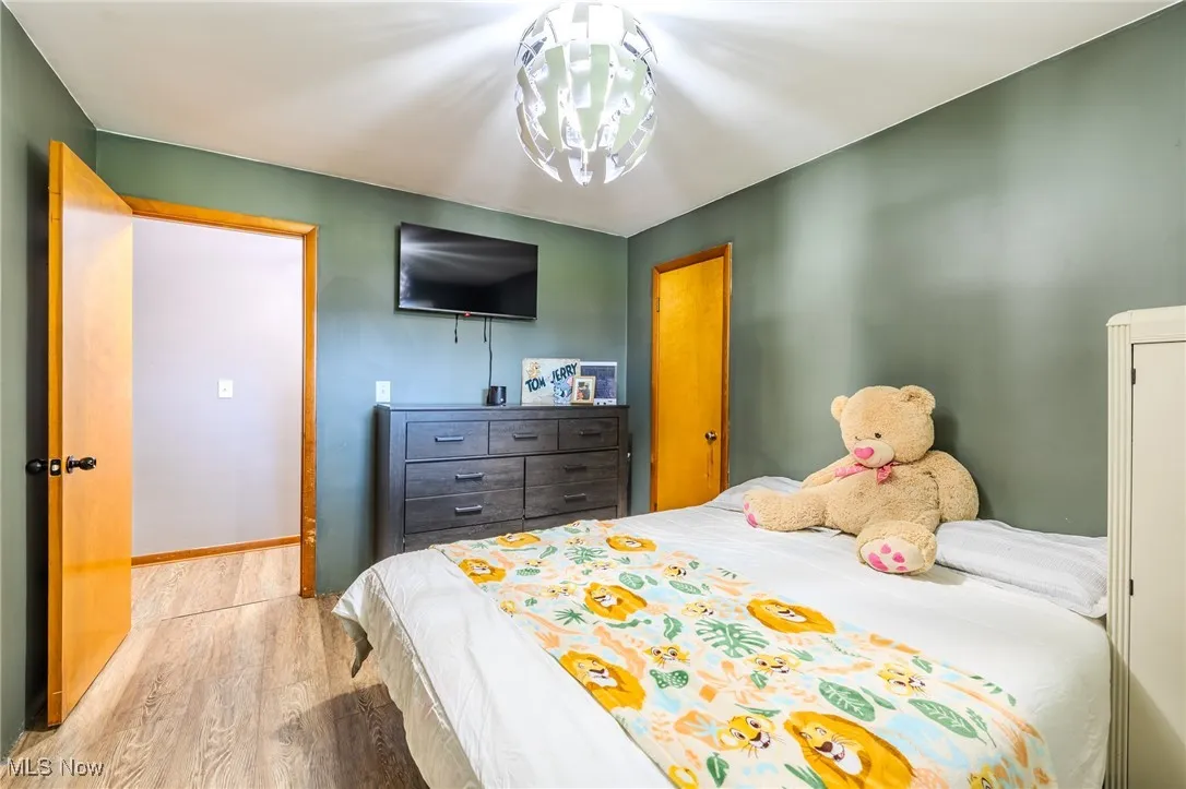 Bedroom featuring wood finished floors and baseboards