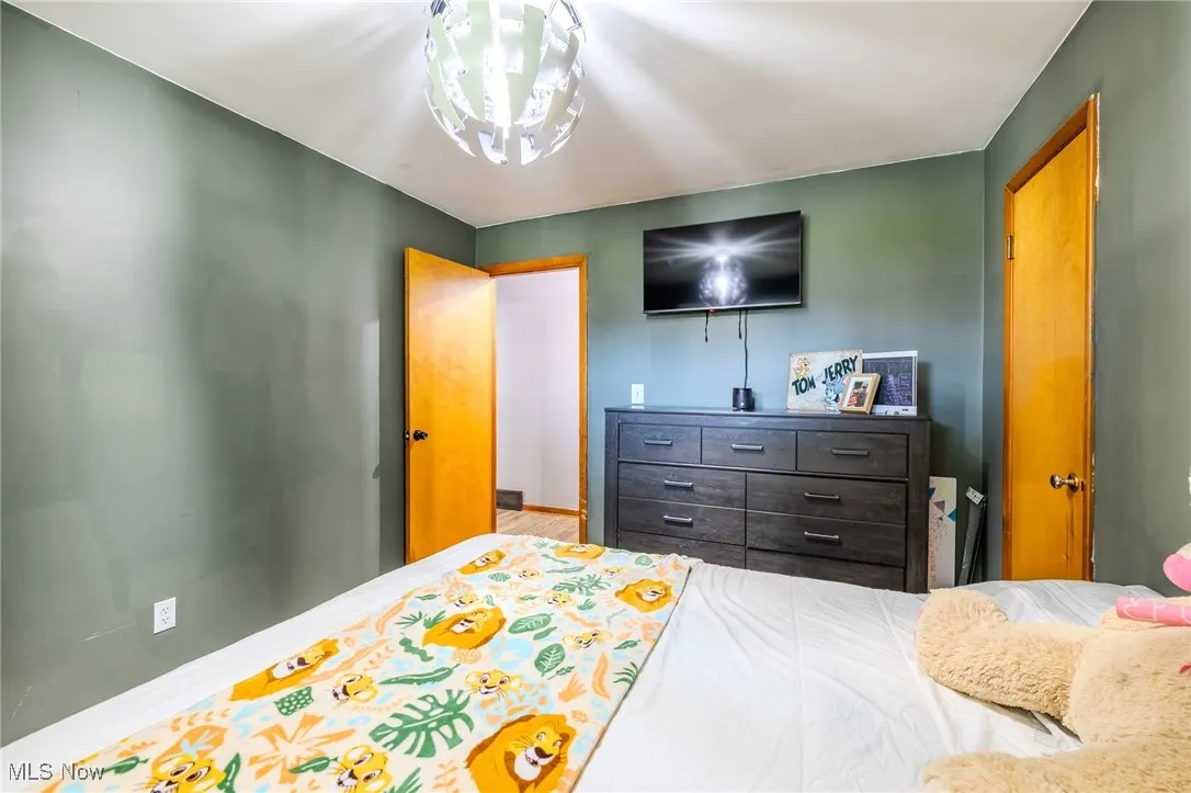 Bedroom featuring baseboards and a chandelier
