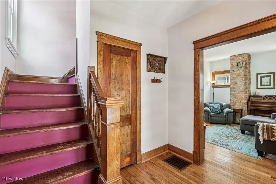 Stairway featuring hardwood / wood-style floors and baseboards