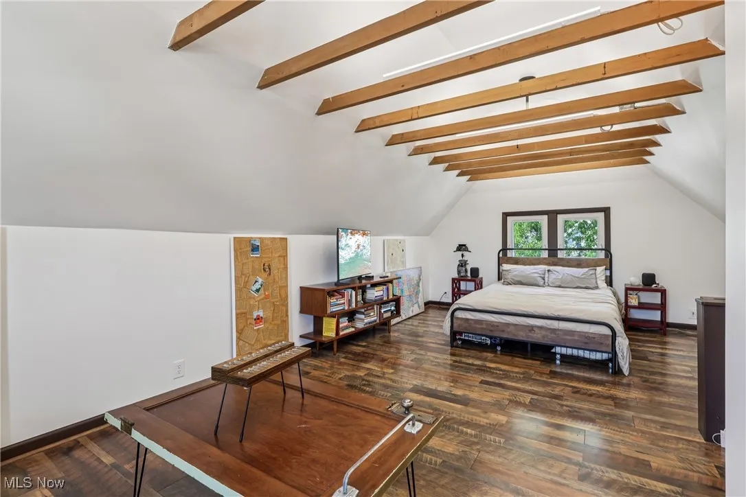 Bedroom featuring wood finished floors and baseboards