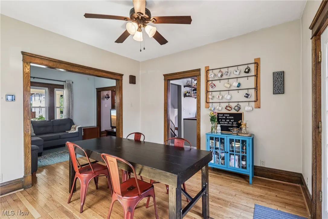 Dining space with light wood-style floors and ceiling fan