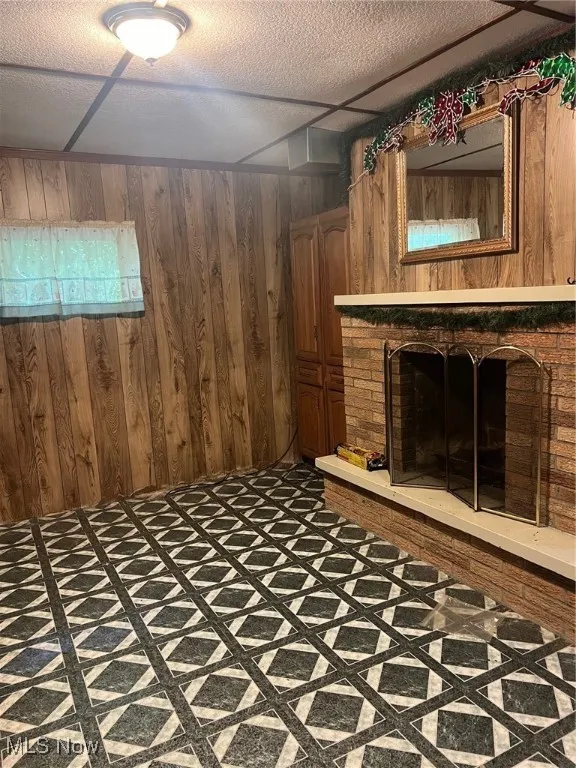 Basement rec room with a brick fireplace