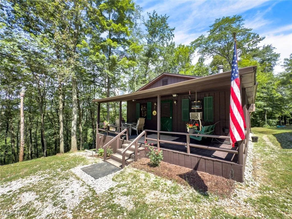 View of front of property with view of wooded area and board and batten siding