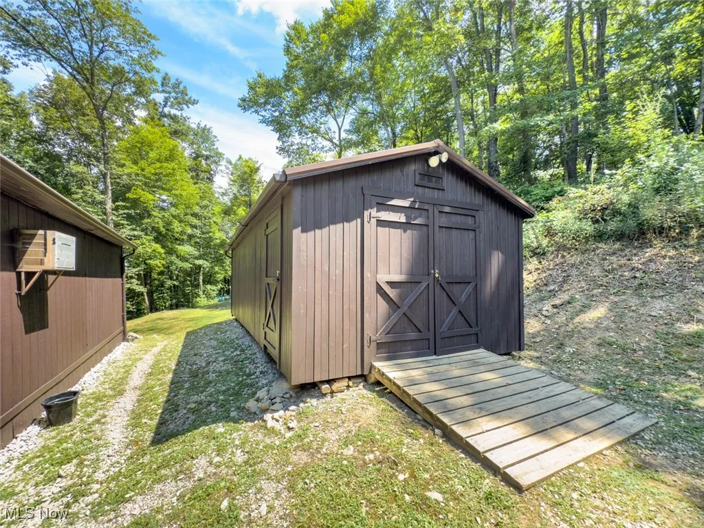View of shed featuring view of scattered trees