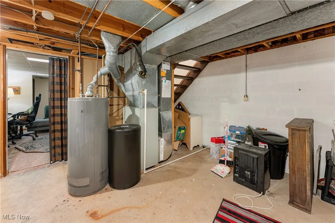 Unfinished below grade area with heating unit and water heater