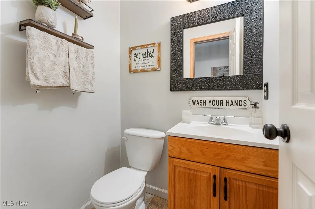 Half bath featuring toilet and vanity