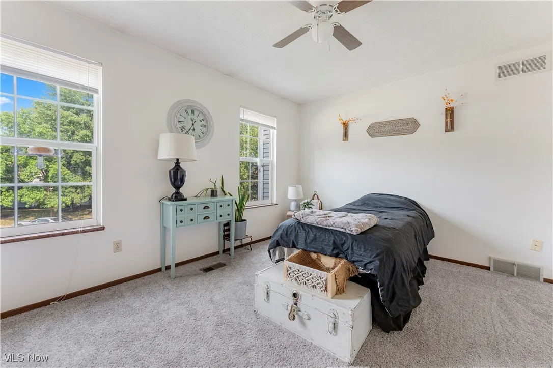 Bedroom with carpet floors and a ceiling fan