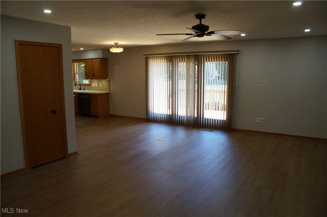 Unfurnished living room featuring recessed lighting, a ceiling fan, wood finished floors, and a textured ceiling