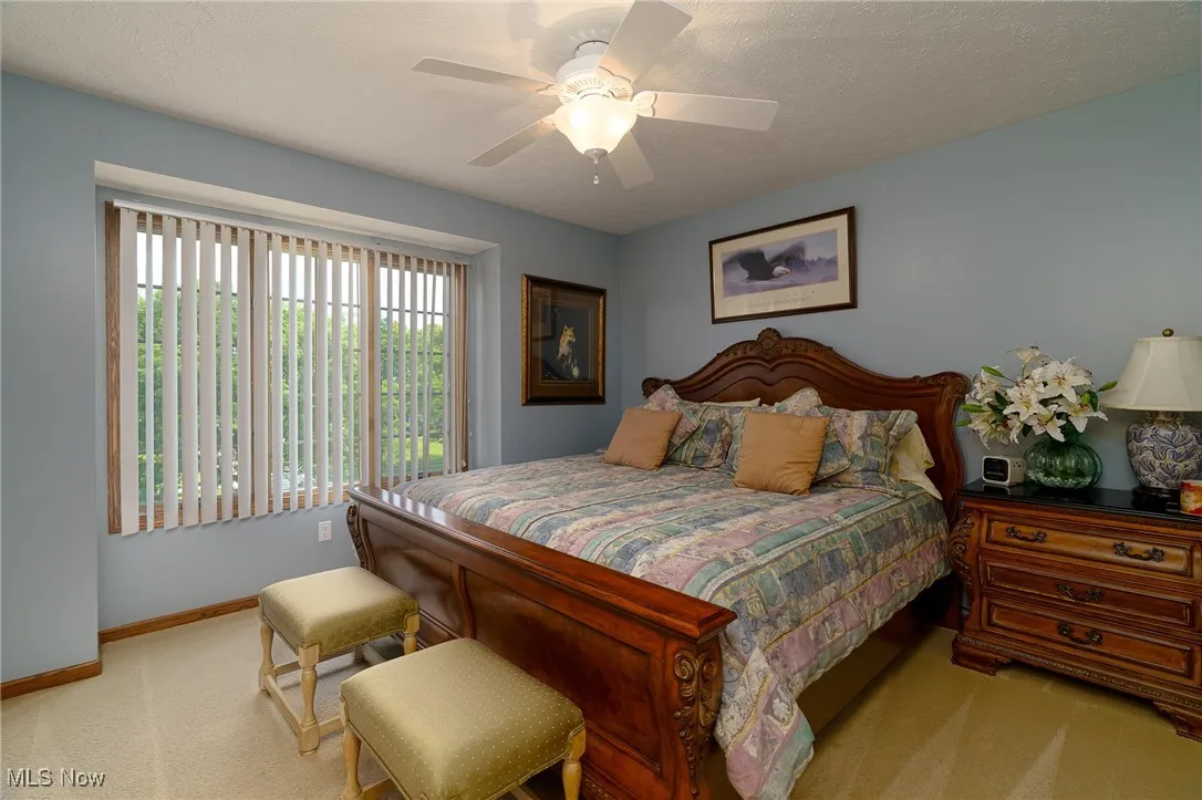 Bedroom featuring light colored carpet and ceiling fan