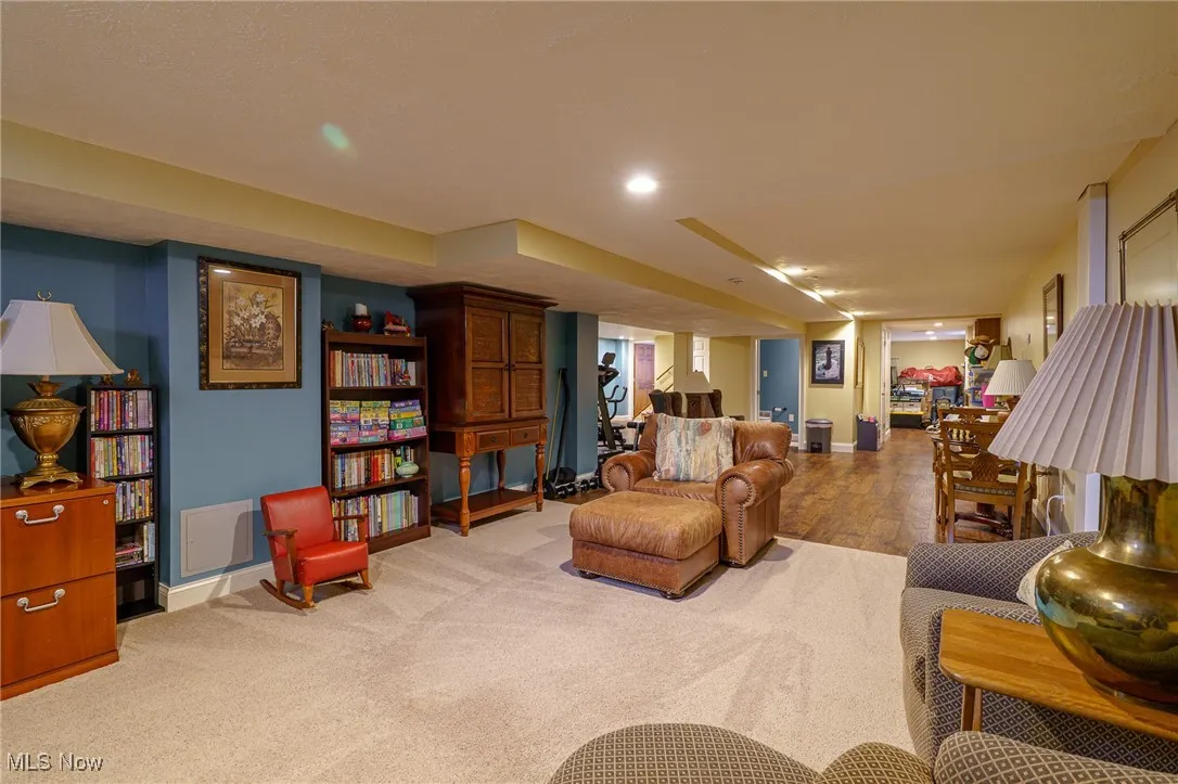 Carpeted living room featuring baseboards and recessed lighting