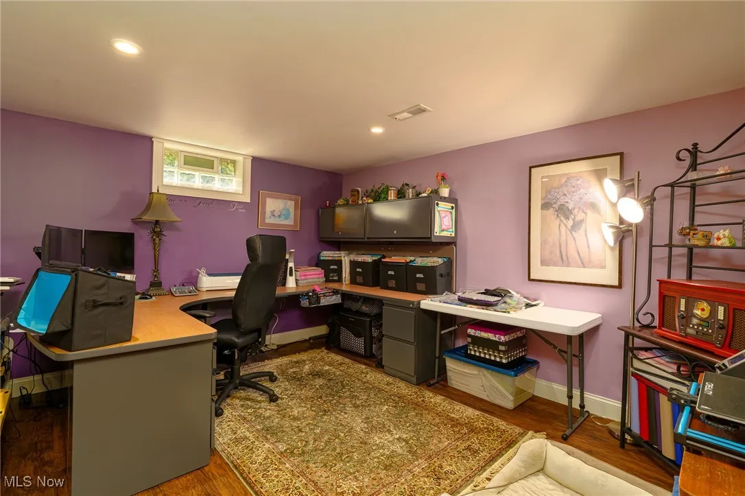 Craft room with wood grained vinyl floors and recessed lighting