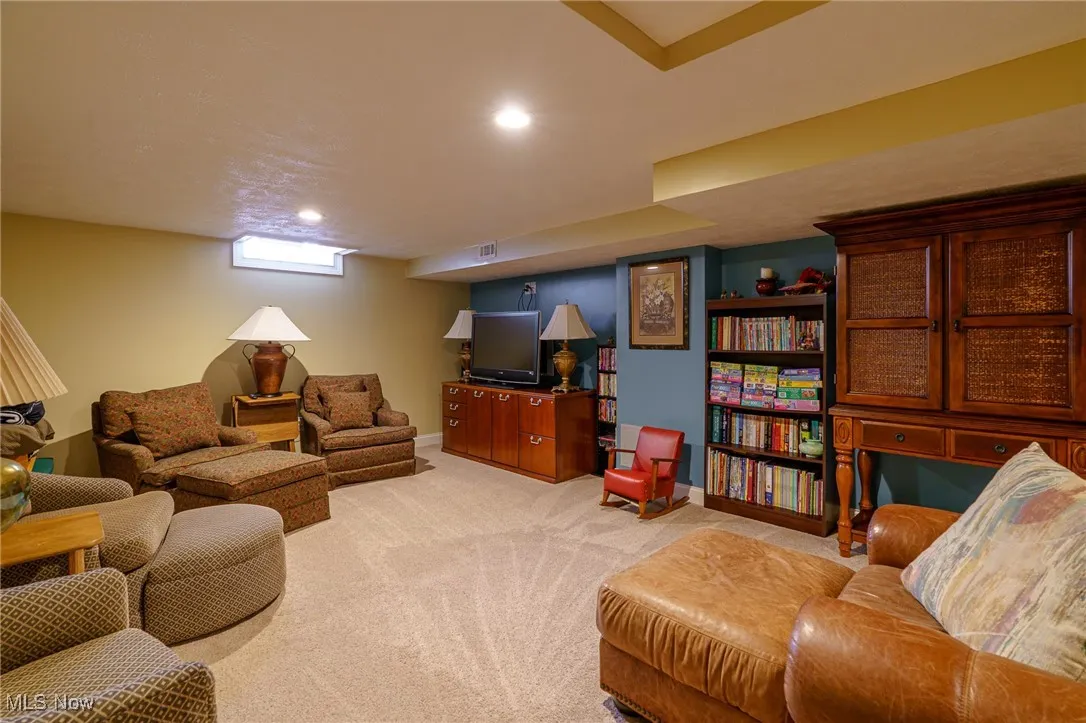 Living area featuring light carpet and recessed lighting