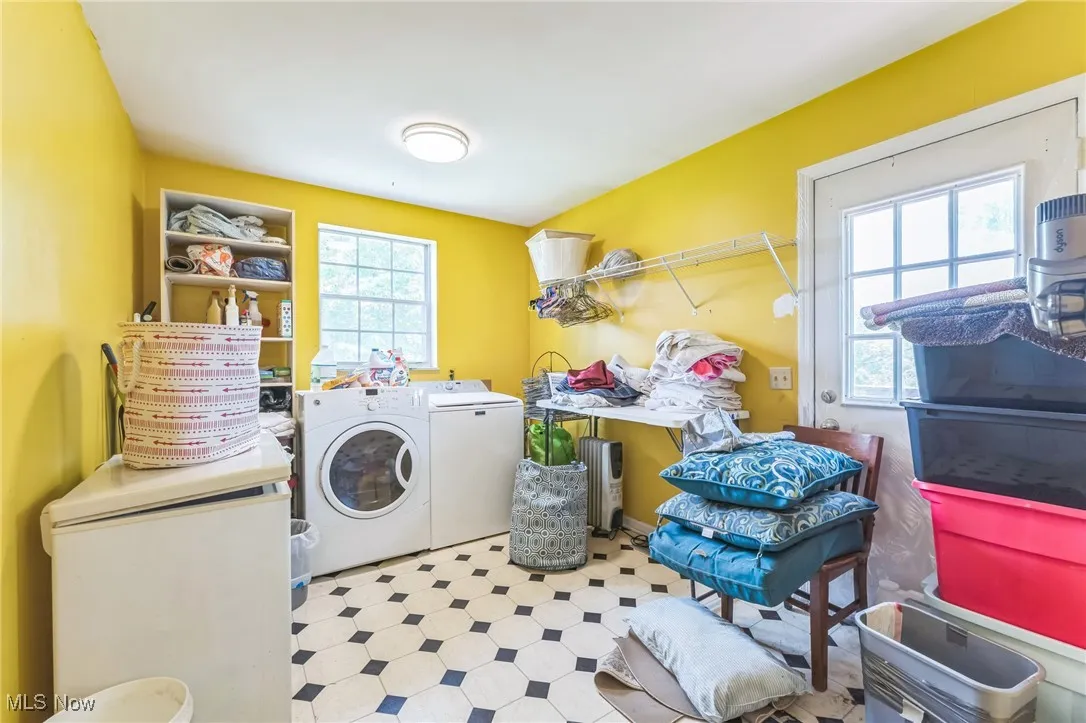 Washroom featuring independent washer and dryer and tile patterned floors