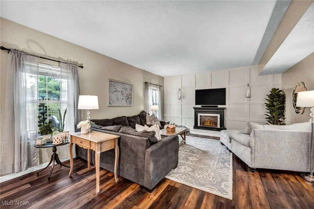 Living room with dark wood-style flooring and fireplace