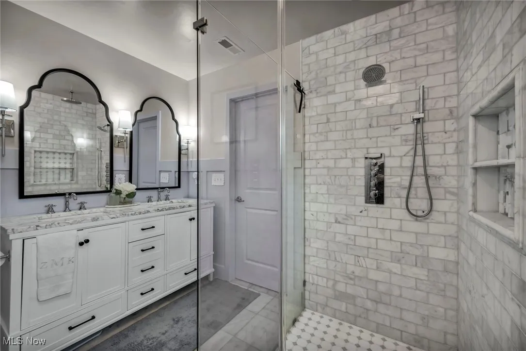 Full bath with a shower stall and double​​‌​​​​‌​​‌‌​‌‌​​​‌‌​‌​‌​‌​​​‌​​ vanity