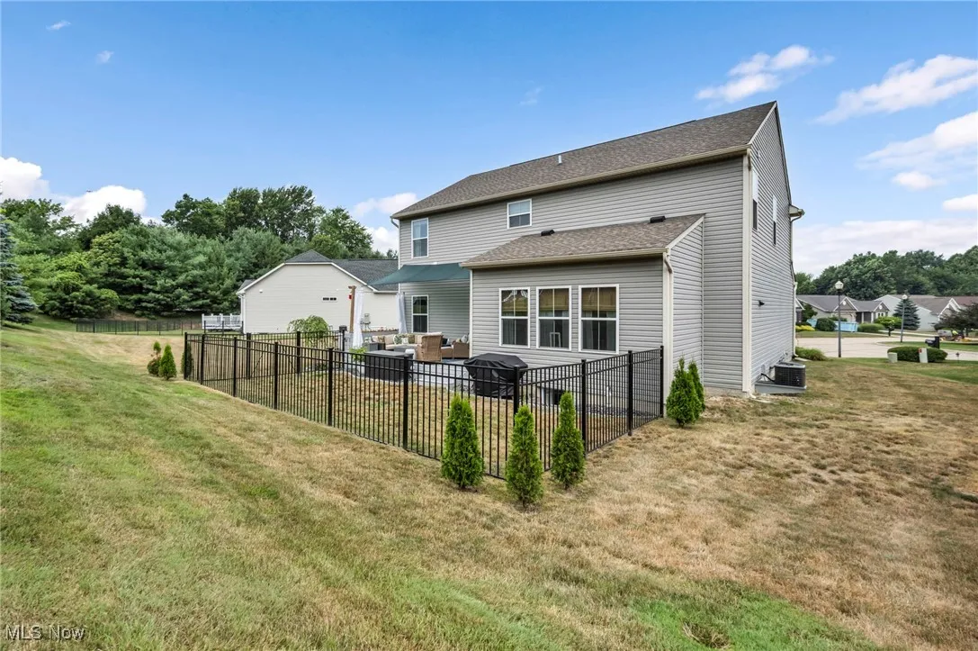 Back of property with roof with shingles, a patio area, and outdoor lounge area