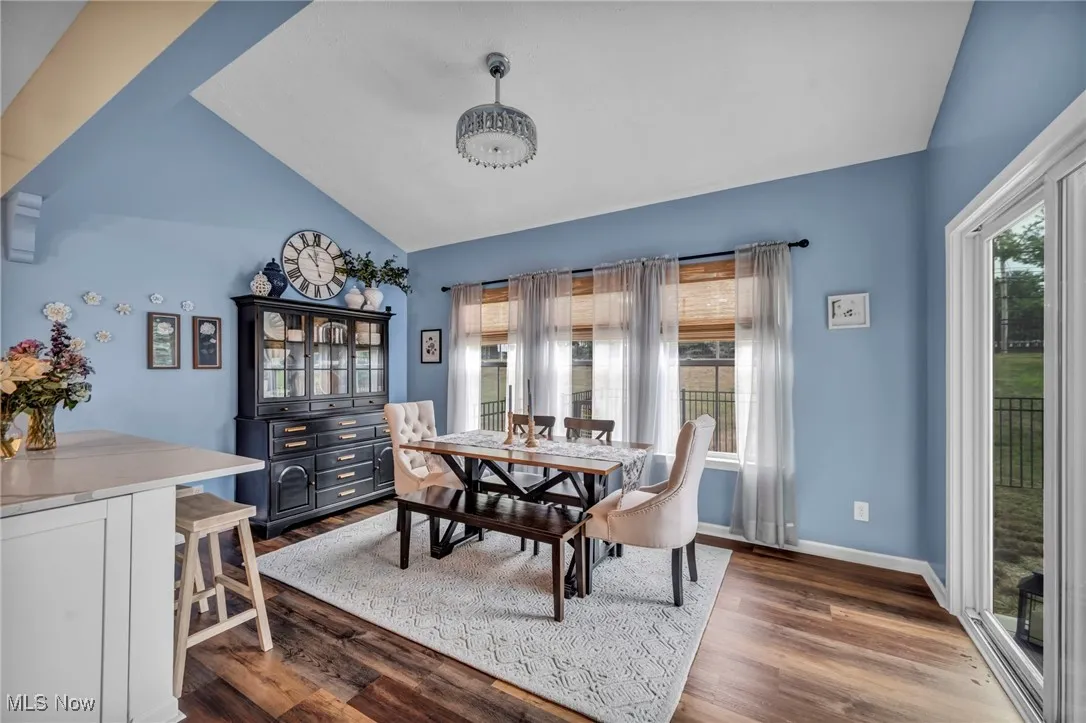 Dining area featuring vaulted ceiling and wood finished floors