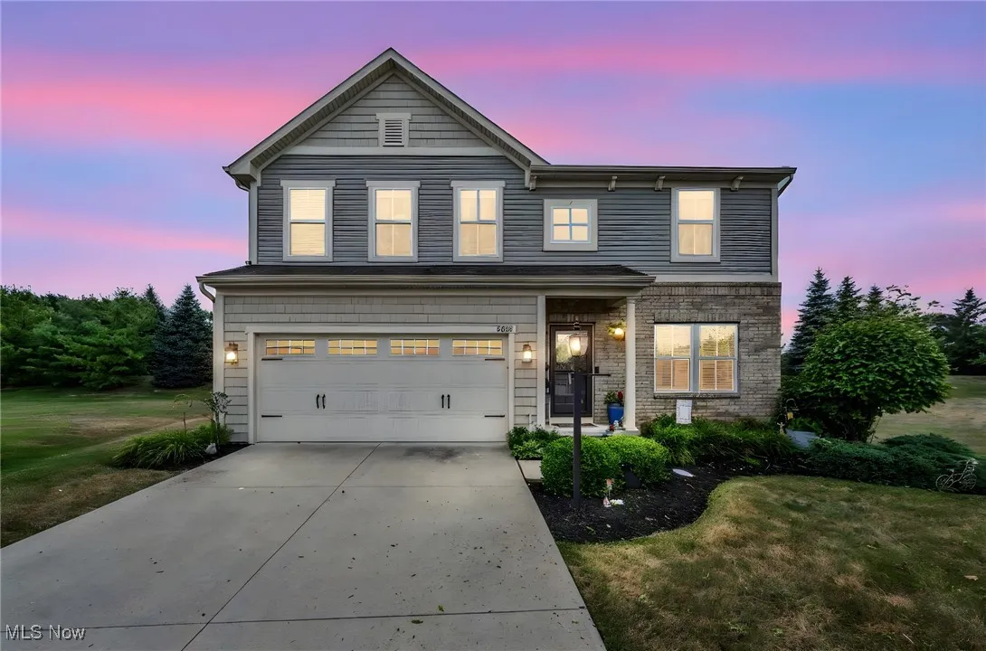 Traditional-style house featuring driveway, a garage, and a front lawn, located on Cul-de-sac