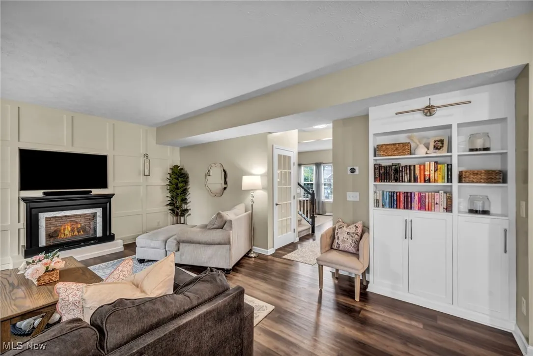 Living area with dark wood-type flooring and  fireplace