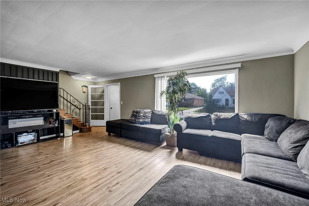 Living room with stairs and wood finished floors
