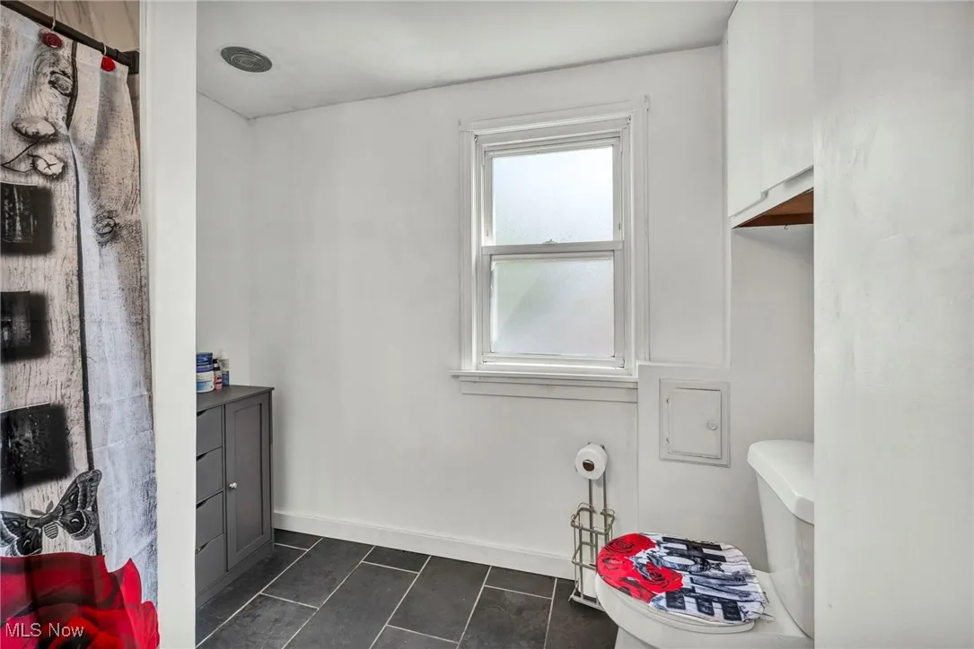 Bathroom featuring toilet and tile patterned flooring