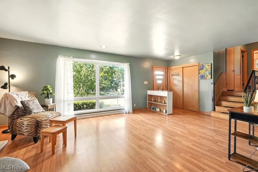 Living room with hardwood floors on main level of home, includes built-in features.