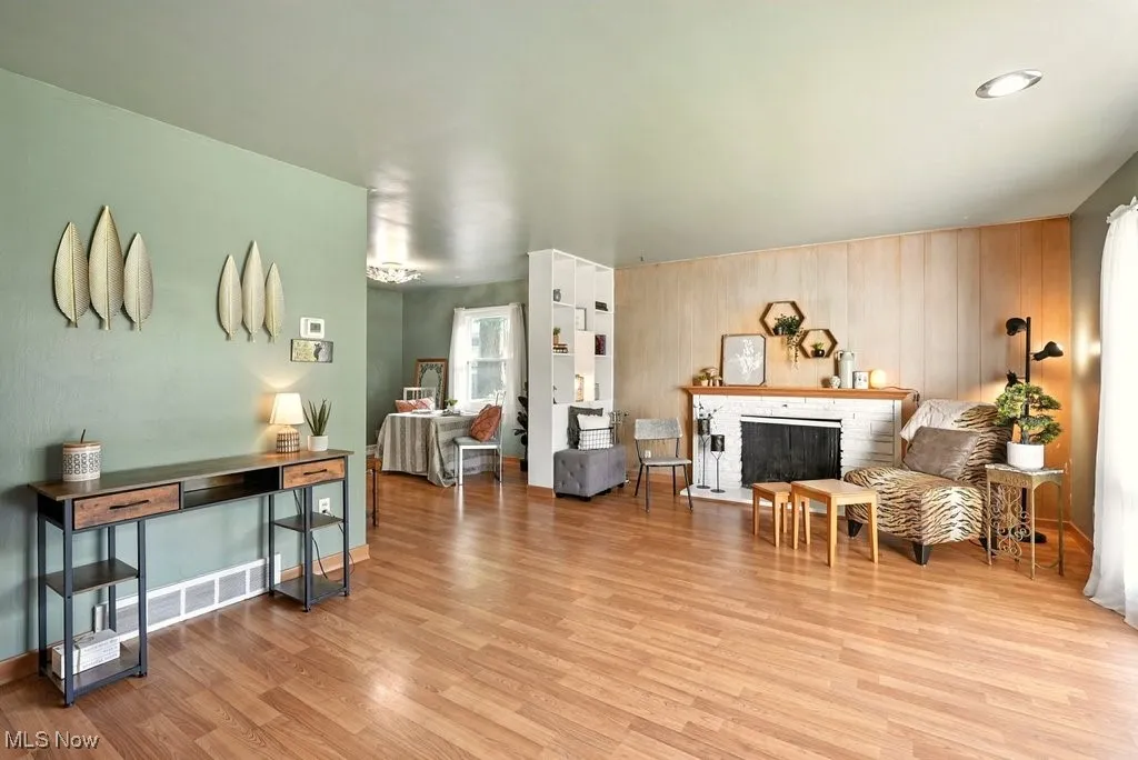 Living area with a fireplace and wood finished floors