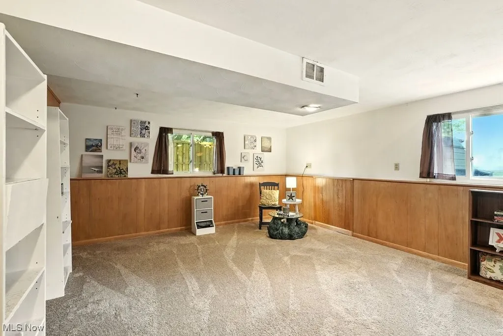 Bonus room with carpet, leading to garage