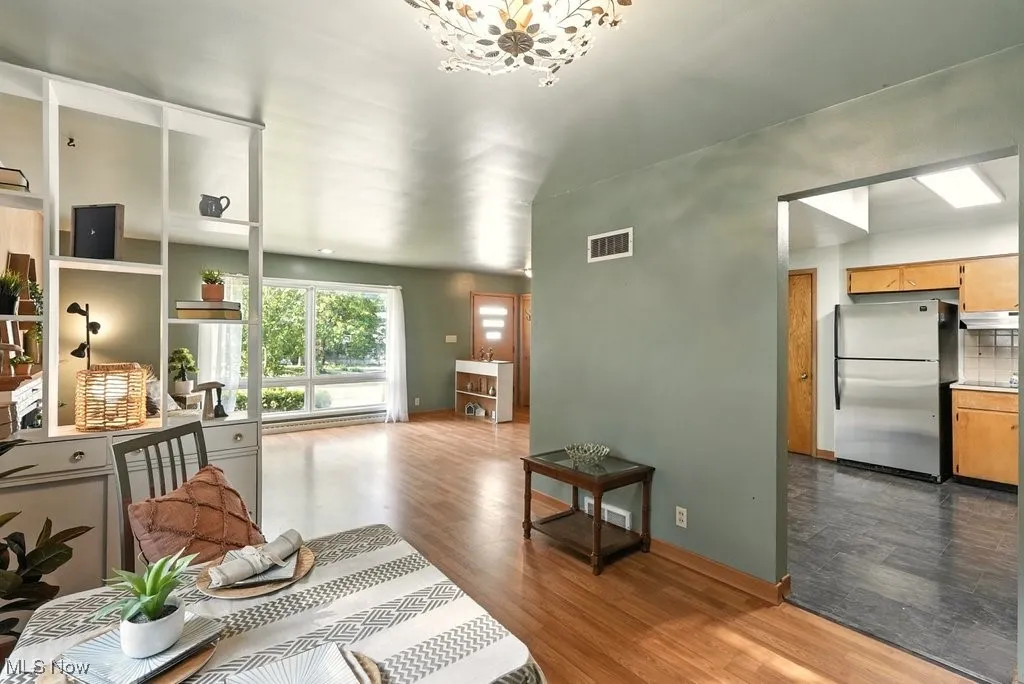 Living room featuring dark wood-type flooring and a chandelier