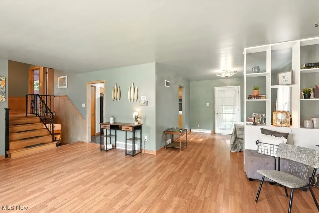 View of stairwell to upstairs and built-in bookcase between the dining room and living room
