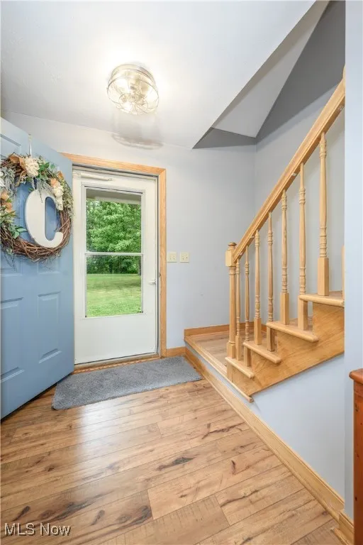 Entryway featuring hardwood / wood-style flooring and stairway