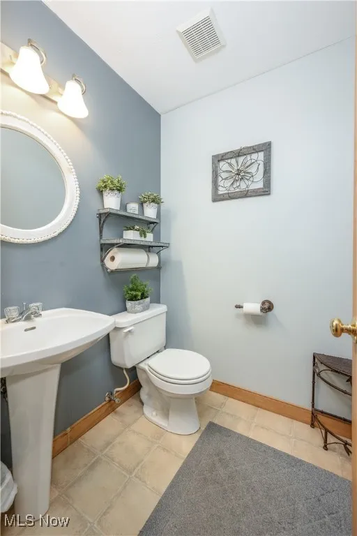 Bathroom with toilet and baseboards