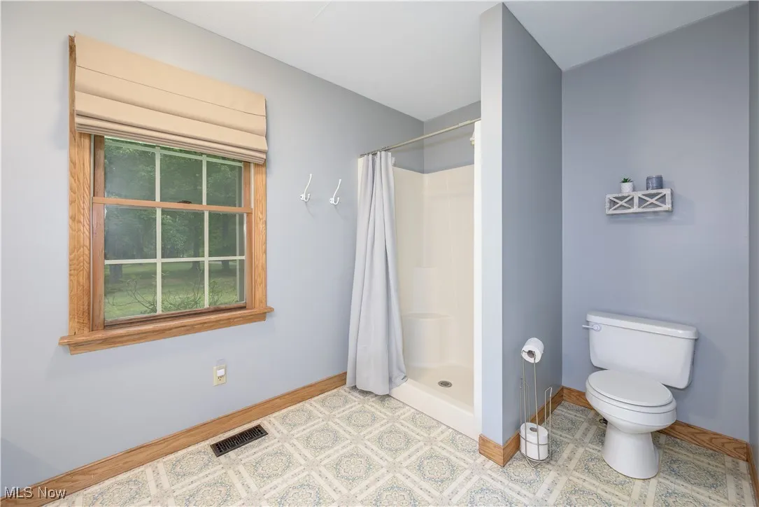 Full bathroom featuring a stall shower