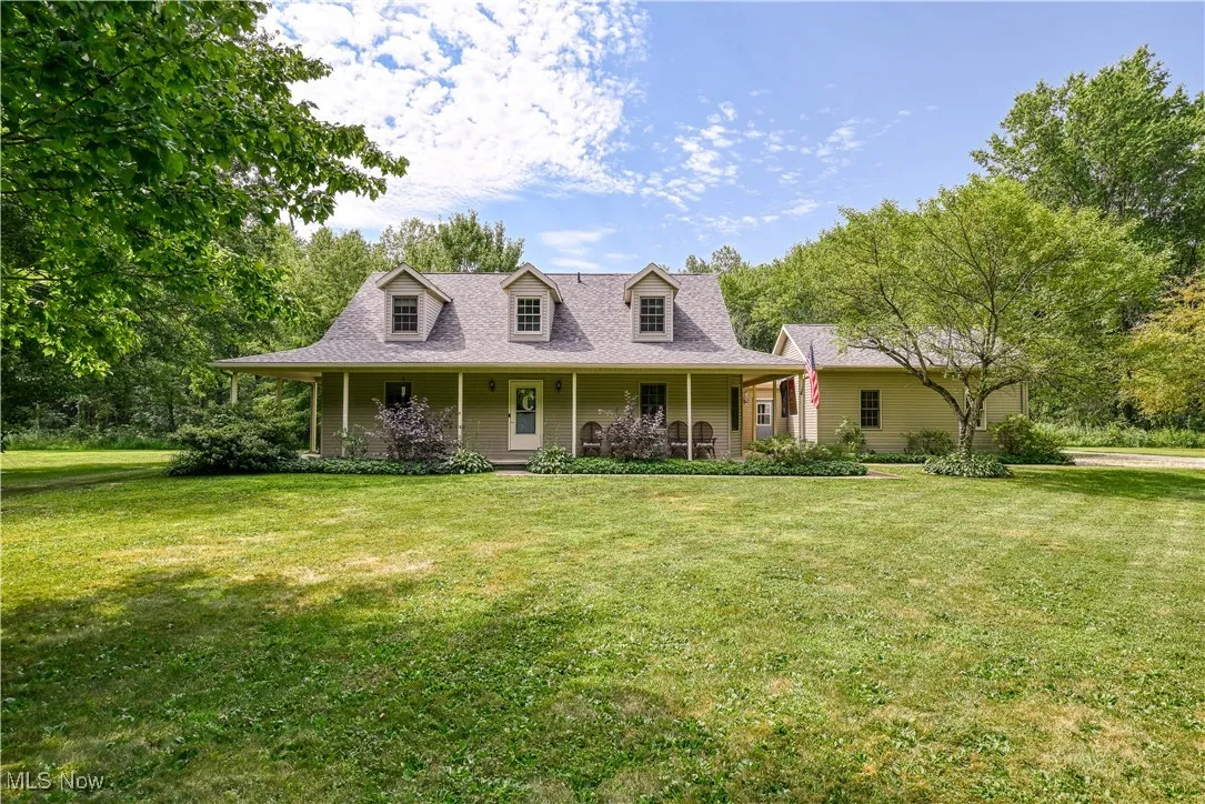 View of front of home featuring covered porch and a front yard